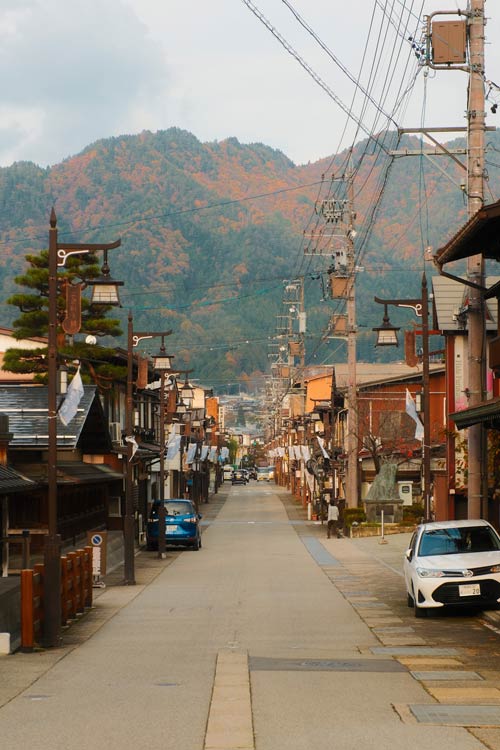 street in hida furukawa with townhouses and cars